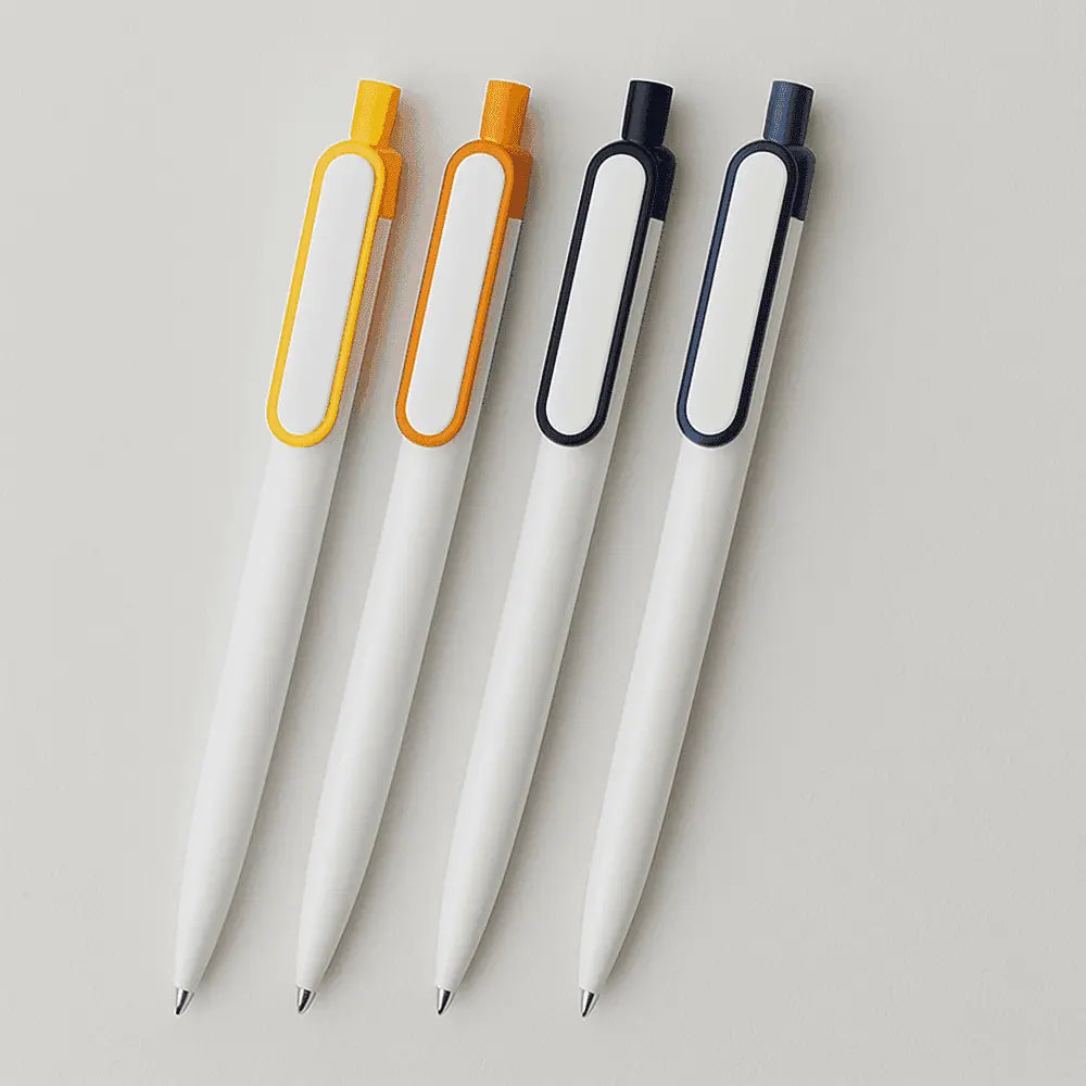 Assorted customizable plastic pens with colored clips in orange, yellow, black, and blue, designed for promotional branding and office use.