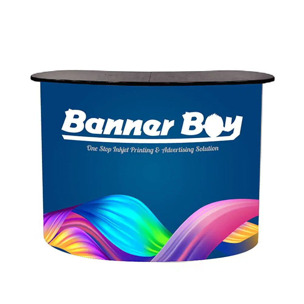 Pop Up Foldable Counter with vibrant Banner Boy branding, ideal for trade shows and events. Features a curved design and portable structure.