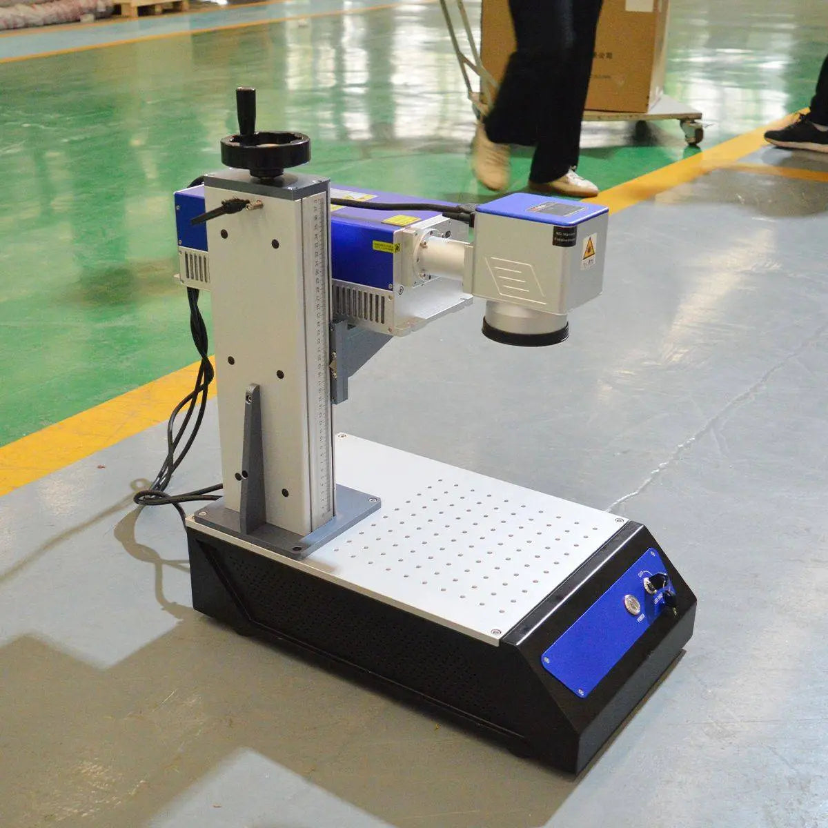 avalaser UV laser engraving machine in industrial setting, highlighting its portability and robust build for professional crafting use.
