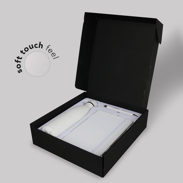 White gift set with stainless bottle, notebook, and pen