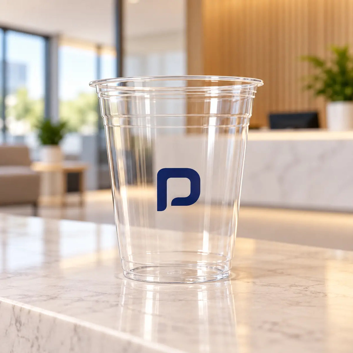 Clear plastic cup with a blue single-color logo | كوب بلاستيكي شفاف بشعار أزرق بلون واحد