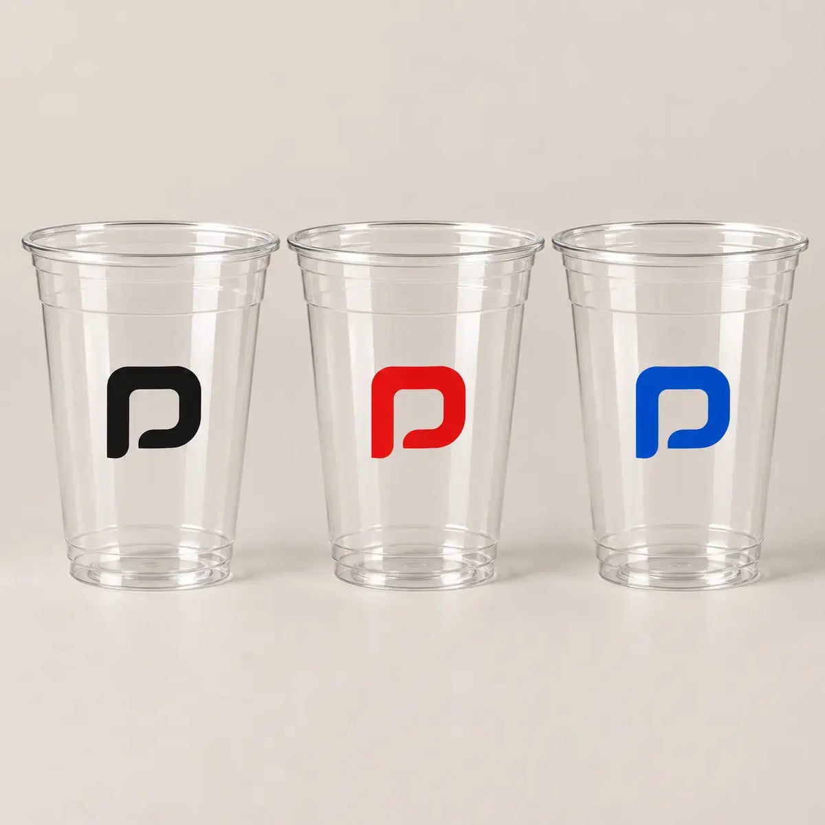 Clear plastic cups with black red and blue single-color logos | أكواب بلاستيكية شفافة بشعارات أحادية بالأسود والأحمر والأزرق